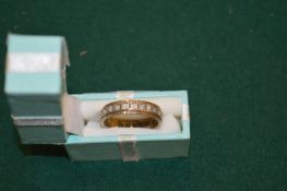 A gold and diamond eternity ring.