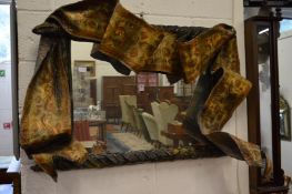An unusual wall mirror with moulded and painted papier mache frame.
