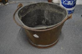 An early copper bucket with wrought iron handle.
