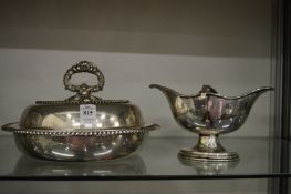 A Sheffield plate circular entree dish cover and handle and a twin handled sauce boat.