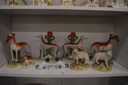 A pair of Staffordshire sheep spill vases, pair of greyhound spill vases, further pair of greyhounds