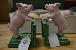 A pair of novelty cast iron bookends modelled as pigs.