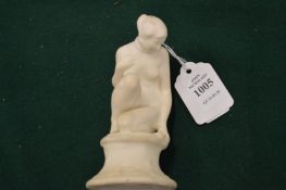 A Royal Doulton bisque porcelain model of a seated female nude.