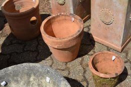 Three terracotta plant pots.