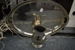 A plated twin handled tray and a jug.