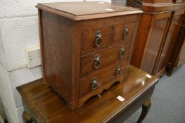 An oak table top chest of drawers.