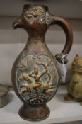 An Islamic embossed copper bird form ewer.