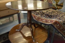 A George III mahogany circular tilt-top tripod table.