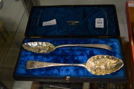 A cased pair of silver berry spoons.