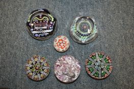 A collection of glass paperweights.