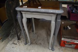 A nest of two painted tables.