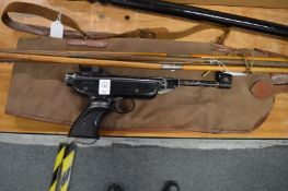 An air pistol, gun cleaning rods and a gun case.