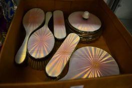 A six piece silver and enamel dressing table set.