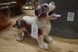A cast iron model of a dog with articulated tongue.