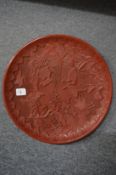 A large Chinese cinnabar lacquer style charger.