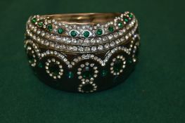 A decorative diamante bangle.