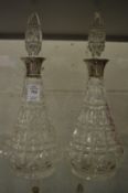 A pair of cut glass and silver mounted decanters.