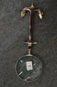 A magnifying glass, the handle modelled as an anchor.