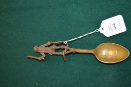 An unusual cast bronze spoon, the handle modelled as a monkey holding a stick.