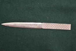 An engine turned silver letter opener.