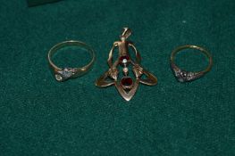 Two gold rings and a pendant.