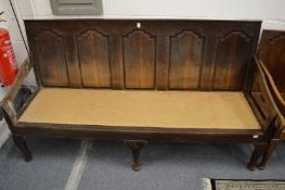 An 18th century oak panel back settle.