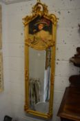 A pair of decorative gilt framed narrow mirrors with portrait panels.