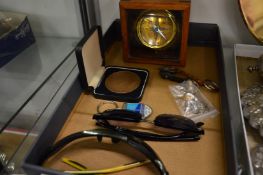 Brass compass, key rings, sunglasses and a medallion.