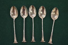 A set of five silver coffee spoons.