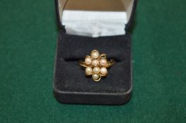 A 9ct gold and seed pearl flower head ring.
