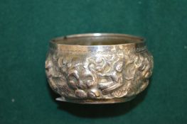 A Burmese silver bowl with embossed decoration.