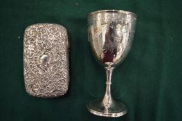 A silver goblet and silver backed brush.