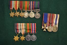 Three sets of miniature medals.