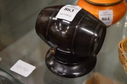 A barrel shaped string or thread dispenser.