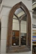 A gothic arch shaped mirror.