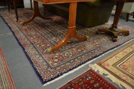 A large Persian design carpet, blue ground with stylised floral decoration, 325cm x 235cm.