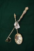 A silver handled candle snuffer and an apostle spoon.
