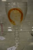 Large Continental ale or wine glass, part amber tinted, engraved with panels depicting building,