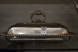 A Walker & Hall silver entree dish with cover and handle.