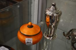 An orange enamelled bowl and cover together with a plated jar and cover.