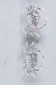 A PAIR OF SILVER PLATED CRAB SALTS.