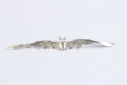 A SILVER BAT BROOCH.