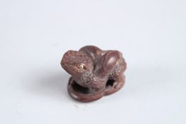 A CARVED HARDWOOD FROG NETSUKE. 1.5ins high.
