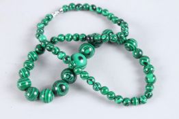 A STRING OF MALACHITE BEADS. 20ins long.