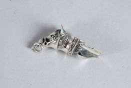 A SILVER HORSE WHISTLE.