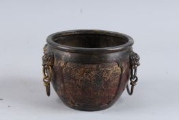A CHINESE GILT BRONZE CIRCULAR BOWL with lion masks. 6ins diameter.