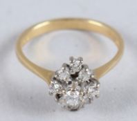AN 18CT GOLD DIAMOND CLUSTER RING.