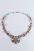 A TIBETAN TURQUOISE, SILVER AND CORAL NECKLACE.