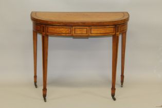A GEORGE III SATINWOOD CARD TABLE with folding top, green baize cover, on tapering legs with brass