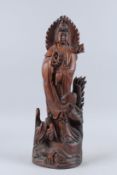 A CHINESE CARVED WOOD GUANYIN FIGURE. 22ins high.